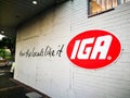 IGA Australian supermarket group brand logo on a wall with slogan `How the locals like it`